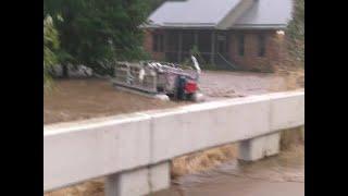 Drifting boat ripped below bridge as Roan Mountain floods