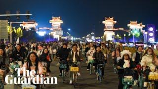 Thousands of Chinese students take part in night cycle ride in search of dumplings