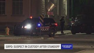 1 in custody after allegedly robbing pedestrian, barricading inside Grand Rapids home