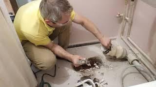 Dismantling an old toilet bowl fixed on cement mortar
