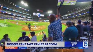 Fans cheer on Dodgers at Cosm venue in Inglewood