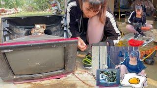 Girl repairs an old TV and restores it to like new condition for customer