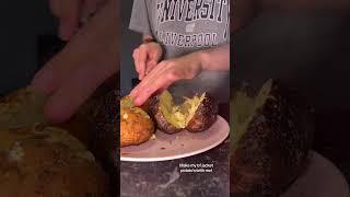 Woman is plating up a jacket potato with beans and cheese!