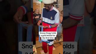 Snoop Dogg holds a gold medal for the first time