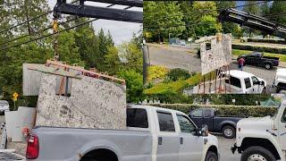 installing waterfall  island Natural Stone letting it with a crane into a house