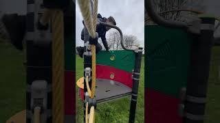 Brandon climbs up a playground