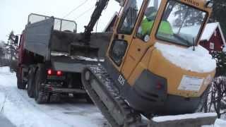 Volvo mini excavator climbing truck.