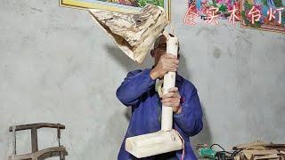 The old rural carpenter made a table lamp made of solid wood, and the master was in the folk