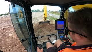 Cutting a bench through the stockpile and Loading big Kenworths