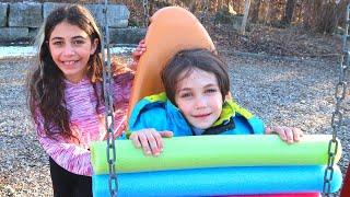 Heidi Guides Zack to Safe Play at the Outdoor Playground