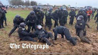 German riot police stuck in mud at coal mine protest