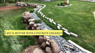 Installing concrete edgers with landscape stone.