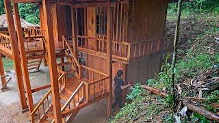 how the girl used wooden planks to make a new door, and finished spray painting the wooden house