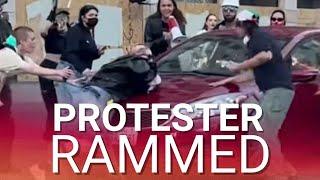Protester run over by moving car as fed-up LA drivers have had enough of disruptive riots