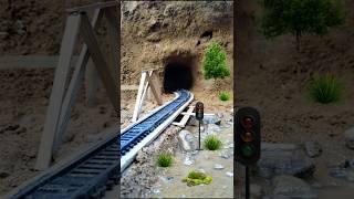 Train Crossing Fragile Wooden Bridge Before Entering the Dark Tunnel