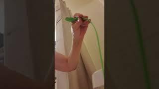 Unclogging bathtub drain using Green Gobbler Snake