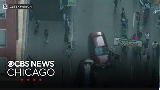 Car speeds through crowd of ICE protesters in Chicago