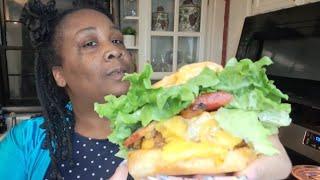 Cooking bacon cheese burgers and fries