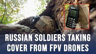 Russian soldiers taking cover from explosive FPV drones operated by Ukrainian forces