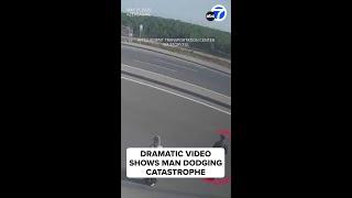 Dramatic video shows man dodging catastrophe on freeway