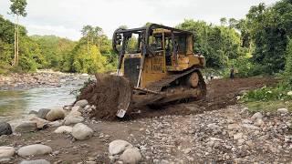 Opening a New Trail with the D6R XL Bulldozer Near the Mountain River