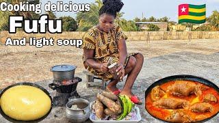 Cooking popular West African Mouthwatering fufu and goat meat light soup in lomé Togo .