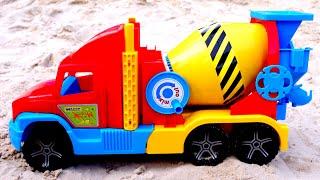 Helper cars in sand. A toy concrete mixer truck. Sand games with toy trucks for kids.