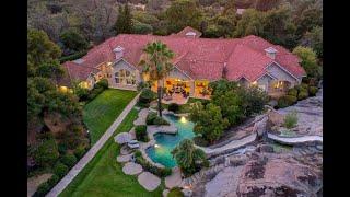 Private 10-acre estate with over 10,000 sq ft of single level living with resort style backyard!