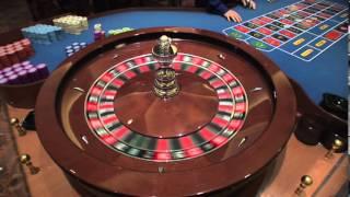 Roulette Wheel Spinning in Las Vegas Casino the Dealer Croupier Rims the ball and Marks Winning Spot