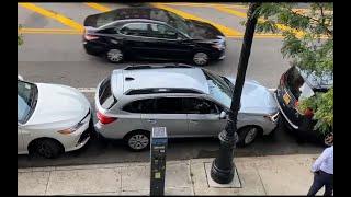 Skilled driver in New York expertly maneuver his car out of a tight parking space