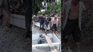 Farmers Team Up to Carry a Concrete Beam for Rural Construction