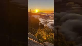 Timelapse of stable air flows over mountain range forming waves in the clouds that resemble an ocean