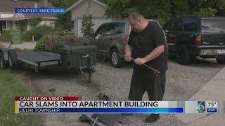 Car slams into apartment building