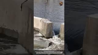 Process of River Unblocking: Crane Lifting a Concrete Plug