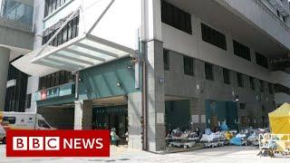 Hong Kong's hospitals overwhelmed amid spike in Covid cases - BBC News