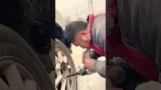 The process of unscrewing wheels in a car using a pneumatic tool