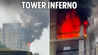 Huge blaze erupts at 15-floor tower block sparking evacuations as 70 firefighters scrambled