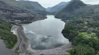 Drone footage from snowdon mountain range with Llanberis and lake