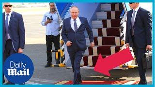 Watch Putin walk and hobble along red carpet with arm hanging limp when arriving in Iran