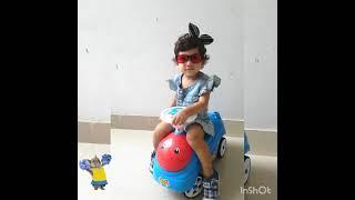 Baby Nitara riding her scooter while enjoying music.