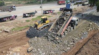 Road construction building mighty machines bulldozer pushing rock gravel for foundation