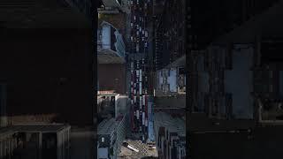 Aerial views showcase cars navigating a bustling Manhattan street in slow motion, with towering