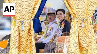 Thailand's king takes part in ancient royal barge procession in Bangkok