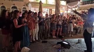 Members of London City Voices sing Kokkino Garryfallo in Spetses, Greece.