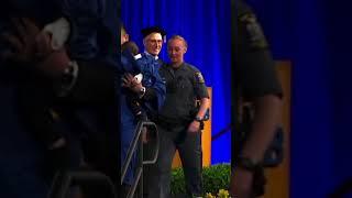 University at Buffalo graduate out runs police while holding infant son during ceremony #shorts
