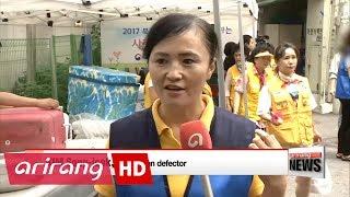 North Korean defectors experience volunteer work for the first time