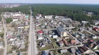 Flight Over Small Town Near Forest With Fast Rotation - cutestockfootage.com