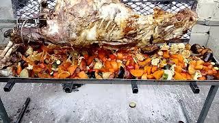 Welcome to Maya Braai and Spit Braai Catering.  whole lamb on spit braai with vegetables 