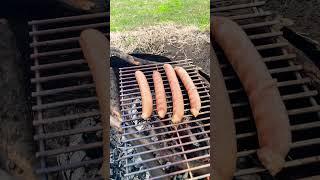 SLO MO cook up sausages on the fire-pit