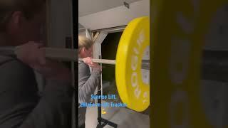 Coach Andrea Hudy counting squat reps with EliteForm’s Lift Tracker.